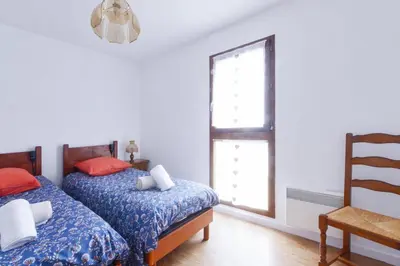 a bedroom with two beds and a window at Appartement Very - Welkeys in Sallanches