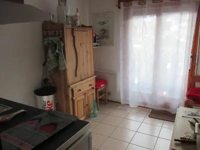 a kitchen with a wooden cabinet and a window at appartement 4 personnes Armancette in Les Contamines-Montjoie