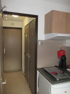 a kitchen with a stove and a door to a room at appartement 4 personnes Armancette in Les Contamines-Montjoie