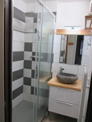a bathroom with a glass shower with a sink at appartement 4 personnes Armancette in Les Contamines-Montjoie