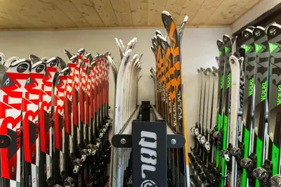 a bunch of skis are lined up against a wall at Chalet-Hôtel La Chemenaz in Les Contamines-Montjoie