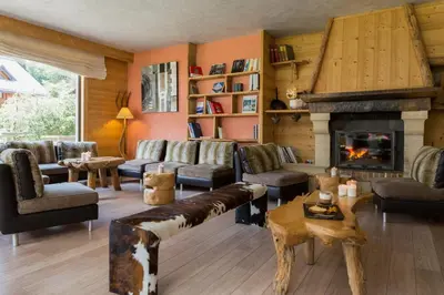 a living room filled with furniture and a fireplace at Chalet-Hôtel La Chemenaz in Les Contamines-Montjoie
