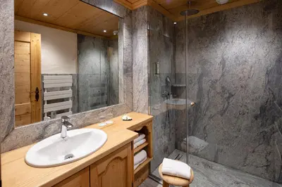 a bathroom with a sink and a shower at Chalet-Hôtel Neige et Roc, The Originals Relais in Samoëns