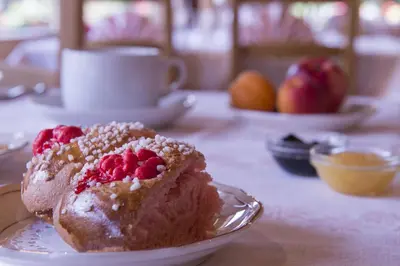 a piece of cake on a plate on a table at Chalet-Hôtel Neige et Roc, The Originals Relais in Samoëns