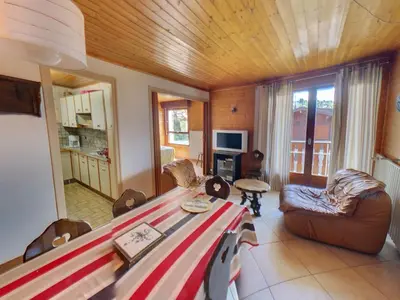 a living room with a table and chairs and a couch at Appartement 6 Pers centre station Carroz (ARB31) in Les Carroz d'Araches