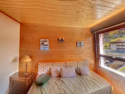 a bedroom with a bed in a room with a window at Appartement 6 Pers centre station Carroz (ARB31) in Les Carroz d'Araches