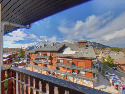 a view from a balcony of a building with a snow covered mountain at Appartement 6 Pers centre station Carroz (ARB31) in Les Carroz d'Araches