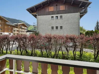 a bench in front of a building with flowers at Appartement 5/6 Pers centre Carroz (ARB 40) in Les Carroz d'Araches