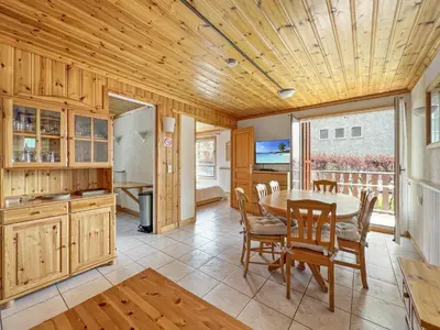 a kitchen and dining room with a table and chairs at Appartement 5/6 Pers centre Carroz (ARB 40) in Les Carroz d'Araches