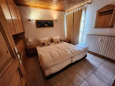 a bedroom with a bed with pillows on it at Appartement 5/6 Pers centre Carroz (ARB 40) in Les Carroz d'Araches