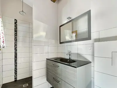 a bathroom with a sink and a mirror at Chalet Haut Standing à proximité du centre (CH228) in Les Carroz d'Araches