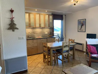 a kitchen and dining room with a table and chairs at Duplex 6/8 Pers Télécabine des Carroz (ES116) in Les Carroz d'Araches