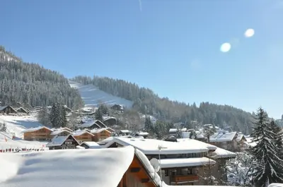 a town covered in snow with a mountain in the background at 2 Pièces 6 Pers centre station (GV211) in Les Carroz d'Araches