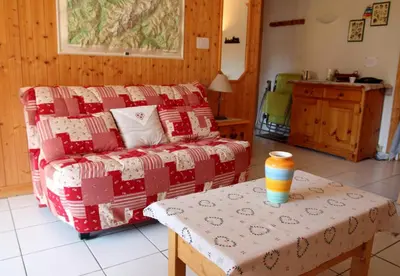 a living room with a couch and a table at 2 Pièces 6 Pers centre station (GV211) in Les Carroz d'Araches