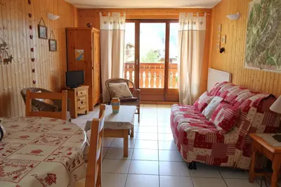 a room with a bed and a couch and a television at 2 Pièces 6 Pers centre station (GV211) in Les Carroz d'Araches