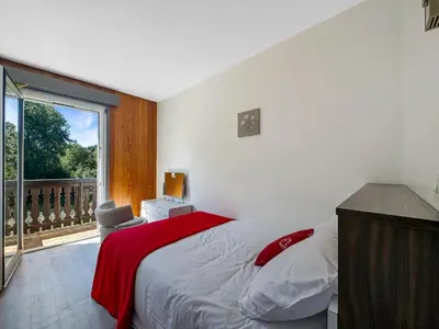 a bedroom with a bed and a balcony with a window at 3 Pièces 6/8 Pers proche centre Carroz (MU0001) in Les Carroz d'Araches