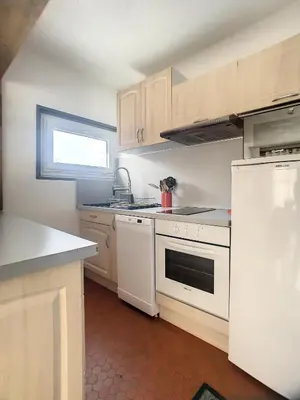 a small kitchen with white appliances and a window at 3 Pièces 6/8 Pers proche centre Carroz (MU0001) in Les Carroz d'Araches