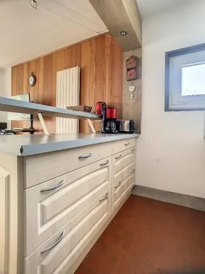 a kitchen with white cabinets and a window at 3 Pièces 6/8 Pers proche centre Carroz (MU0001) in Les Carroz d'Araches