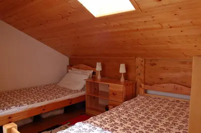 a bedroom with two beds in a cabin at Duplex 6 Pers centre station Carroz (SA315) in Les Carroz d'Araches