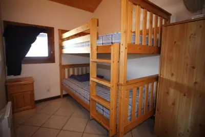 a bedroom with two bunk beds with a ladder at Duplex 6 Pers centre station Carroz (SA315) in Les Carroz d'Araches