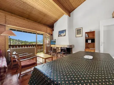 a room with a bed and a table and chairs at Duplex 8 Pers centre des Carroz (SL404) in Les Carroz d'Araches