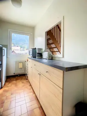 a kitchen with a counter top and a window at Duplex 8 Pers centre des Carroz (SL404) in Les Carroz d'Araches