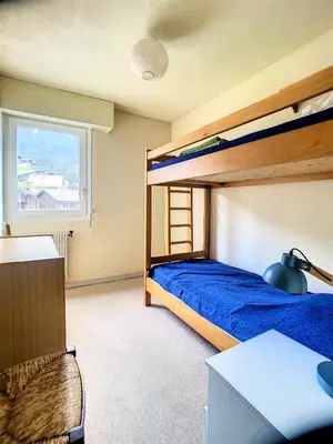 a bedroom with a bunk bed and a desk at Duplex 8 Pers centre des Carroz (SL404) in Les Carroz d'Araches