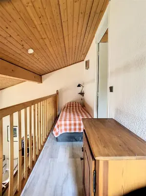 a room with a bed in the corner of a room at Duplex 8 Pers centre des Carroz (SL404) in Les Carroz d'Araches