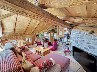 a living room with couches and a stone fireplace at - Duplex Haut Standing 6 pers (ZE101) in Les Carroz d'Araches