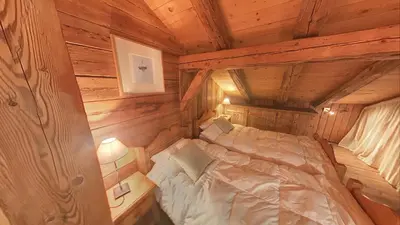 a bedroom in a log cabin with a bed at - Duplex Haut Standing 6 pers (ZE101) in Les Carroz d'Araches