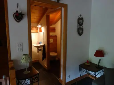 a bathroom with a toilet and a sink in a room at Appartement cosy à Samoëns avec jacuzzi in Samoëns