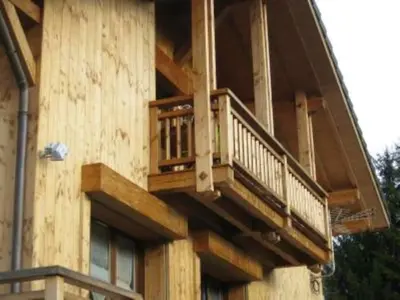 a house with a balcony on the side of it at Appartement cosy à Samoëns avec jacuzzi in Samoëns
