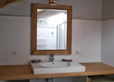 a bathroom with a white sink and a mirror at Appartement cosy à Samoëns avec jacuzzi in Samoëns