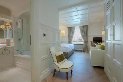 a hotel room with a bedroom and a bathroom at Grand Hôtel des Alpes in Chamonix-Mont-Blanc