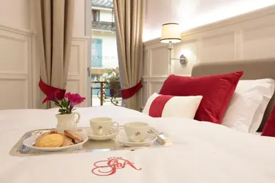 a tray of food on top of a bed at Grand Hôtel des Alpes in Chamonix-Mont-Blanc