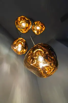a group of lights hanging from a ceiling at Grand Hôtel des Alpes in Chamonix-Mont-Blanc