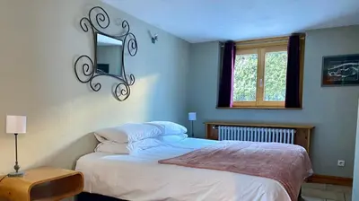 a bedroom with a bed and a window at The Castle, 10 Bedroom Chalet, Chamonix Centre in Chamonix-Mont-Blanc