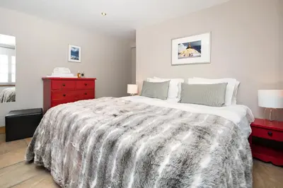 a bedroom with a large bed and a red dresser at The Castle, 10 Bedroom Chalet, Chamonix Centre in Chamonix-Mont-Blanc