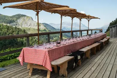 a long table with glasses on it on a deck at Les Fermes de Marie in Megève