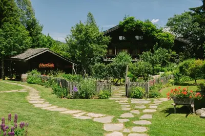 a garden in front of a house at Les Fermes de Marie in Megève