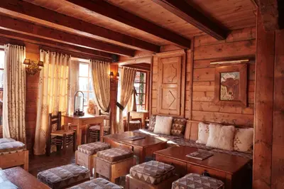 a living room with a couch and a table at Les Fermes de Marie in Megève