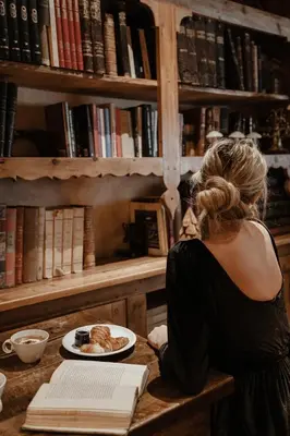 a woman sitting at a table with a plate of food at Hotel Mont Blanc Megève in Megève
