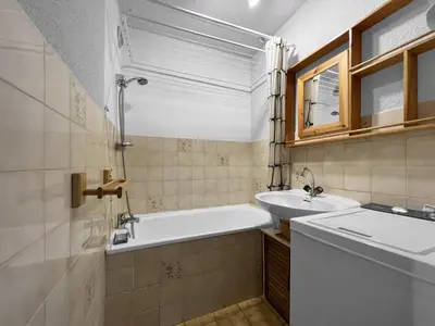 a bathroom with a tub and a sink at Duplex 4 Pers PIed de pistes (BA331) in Les Carroz d'Araches