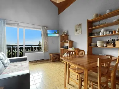 a kitchen and dining room with a table and a window at Duplex 4 Pers PIed de pistes (BA331) in Les Carroz d'Araches