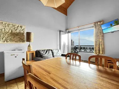 a dining room with a table and a large window at Duplex 4 Pers PIed de pistes (BA331) in Les Carroz d'Araches