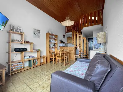 a living room with a couch and a kitchen at Duplex 4 Pers PIed de pistes (BA331) in Les Carroz d'Araches