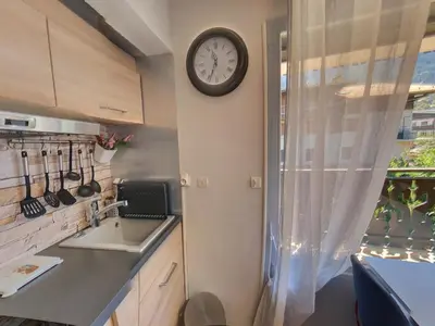 a kitchen with a sink and a clock on the wall at Studio centre Carroz CA210 in Les Carroz d'Araches