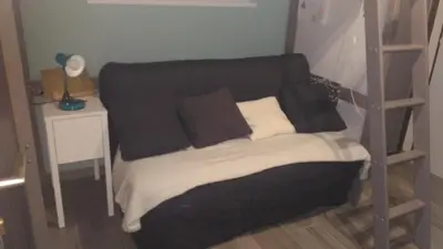 a bedroom with a bed with a black and white blanket at Studio centre Carroz CA210 in Les Carroz d'Araches