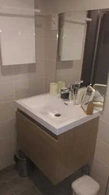 a bathroom with a white sink and a mirror at Studio centre Carroz CA210 in Les Carroz d'Araches