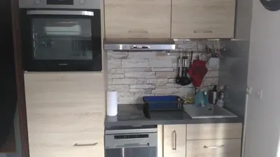a small kitchen with a sink and a microwave at Studio centre Carroz CA210 in Les Carroz d'Araches